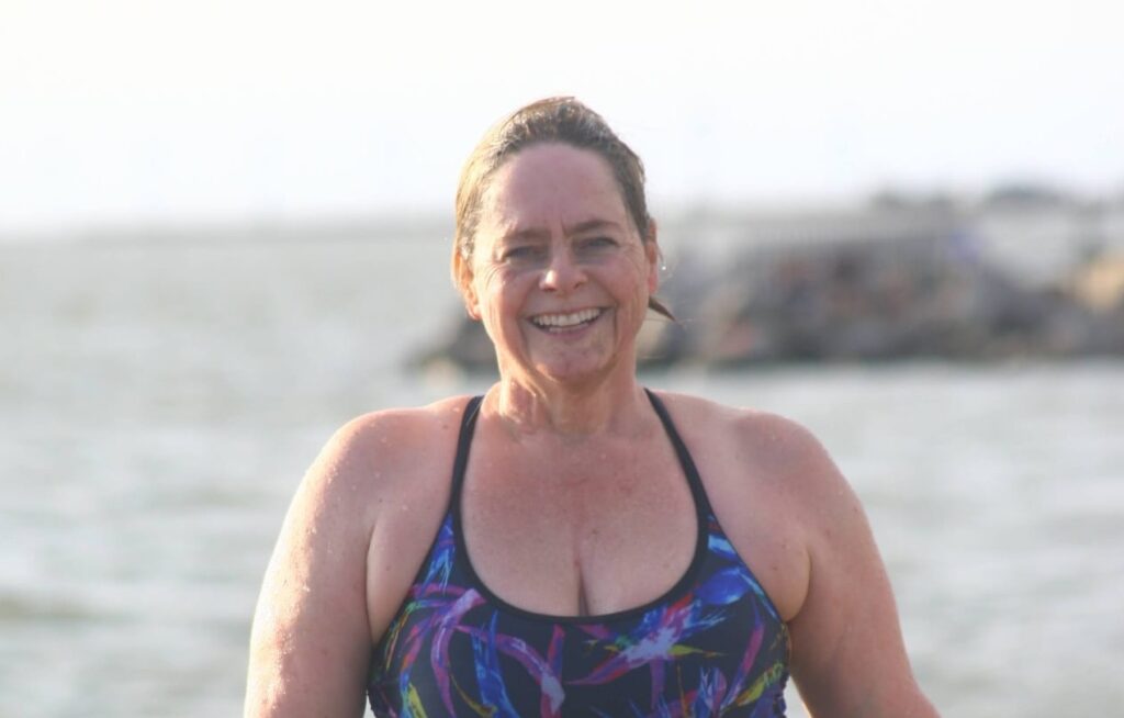 Wendy Cordier in a swimming costume in front of the sea